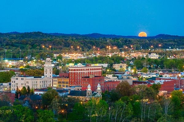 city with rising moon