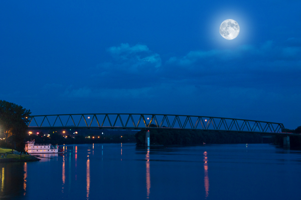 shooting the moon above a bridge at night