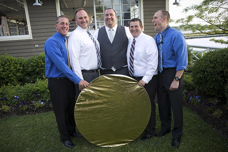 group of men holding a reflector