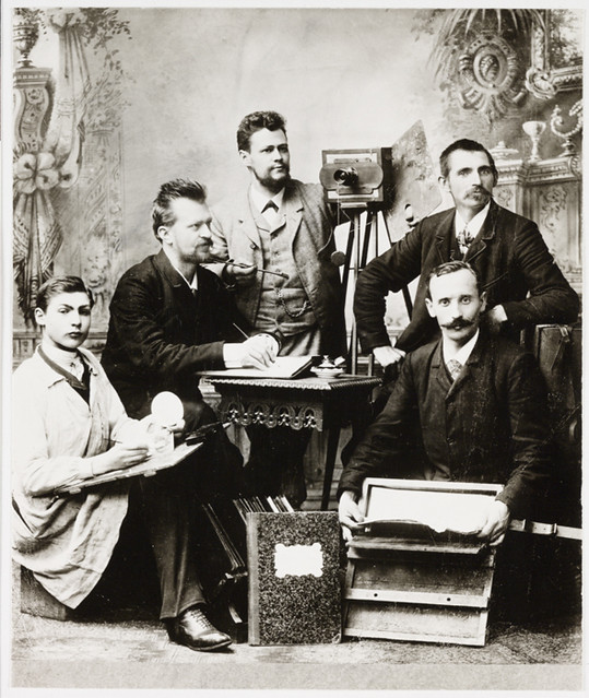 Group of photographers posing in a studio