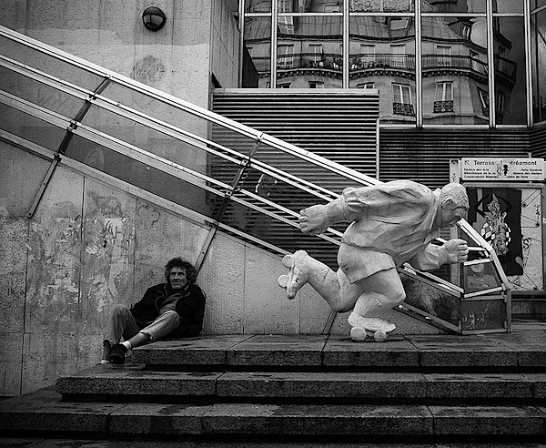 skating statue with a person sitting nearby