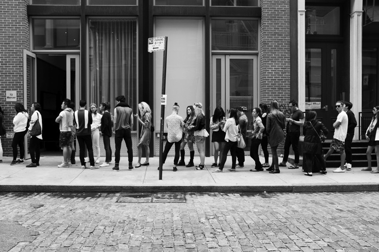 people waiting in line street photography