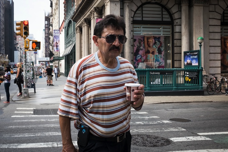 man with coffee walking