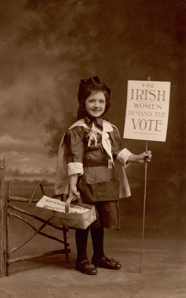 Child holding suffrage placard