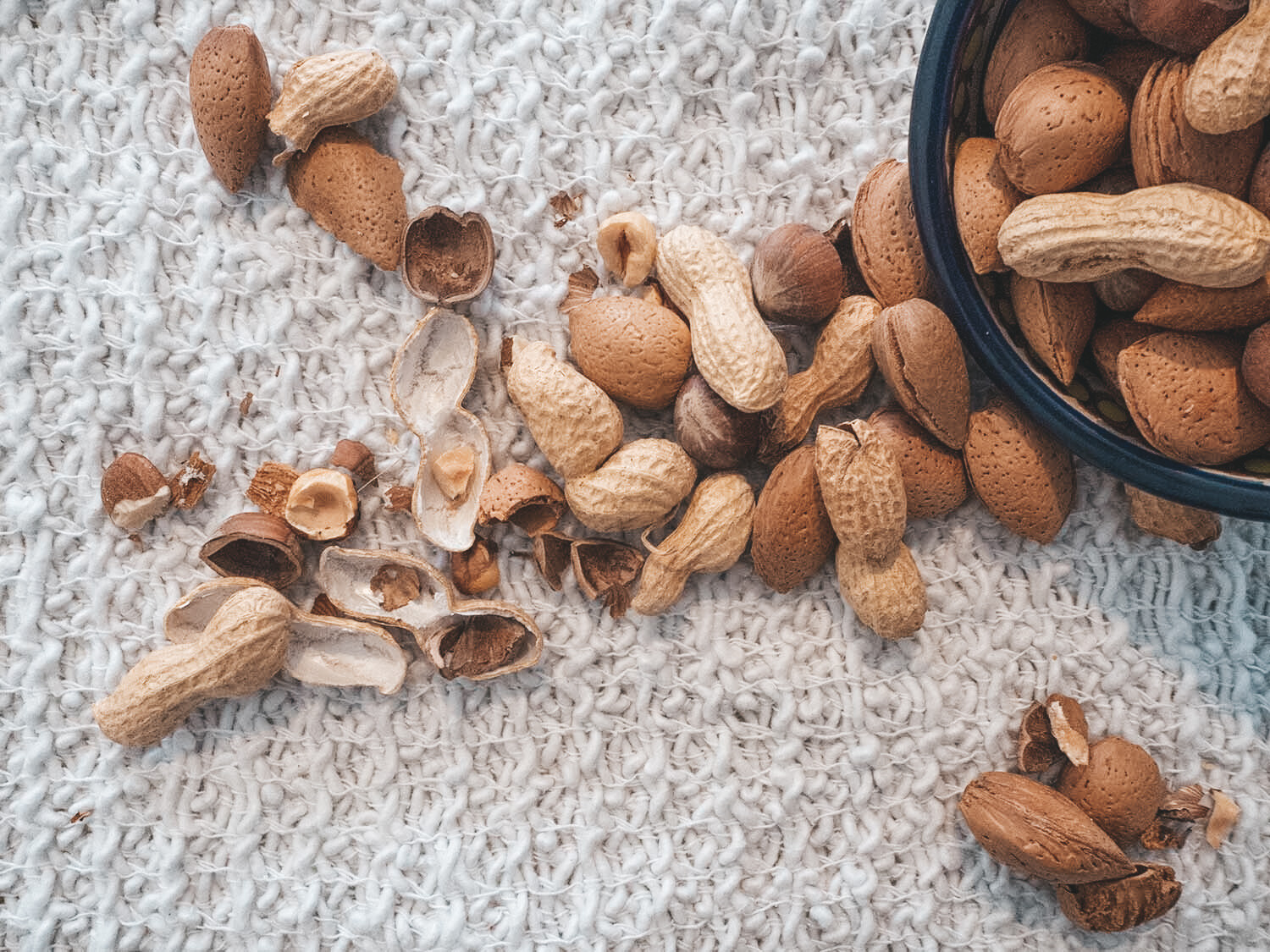 peanuts spilling out of a bowl