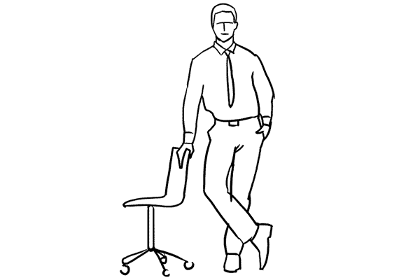 man standing next to a chair