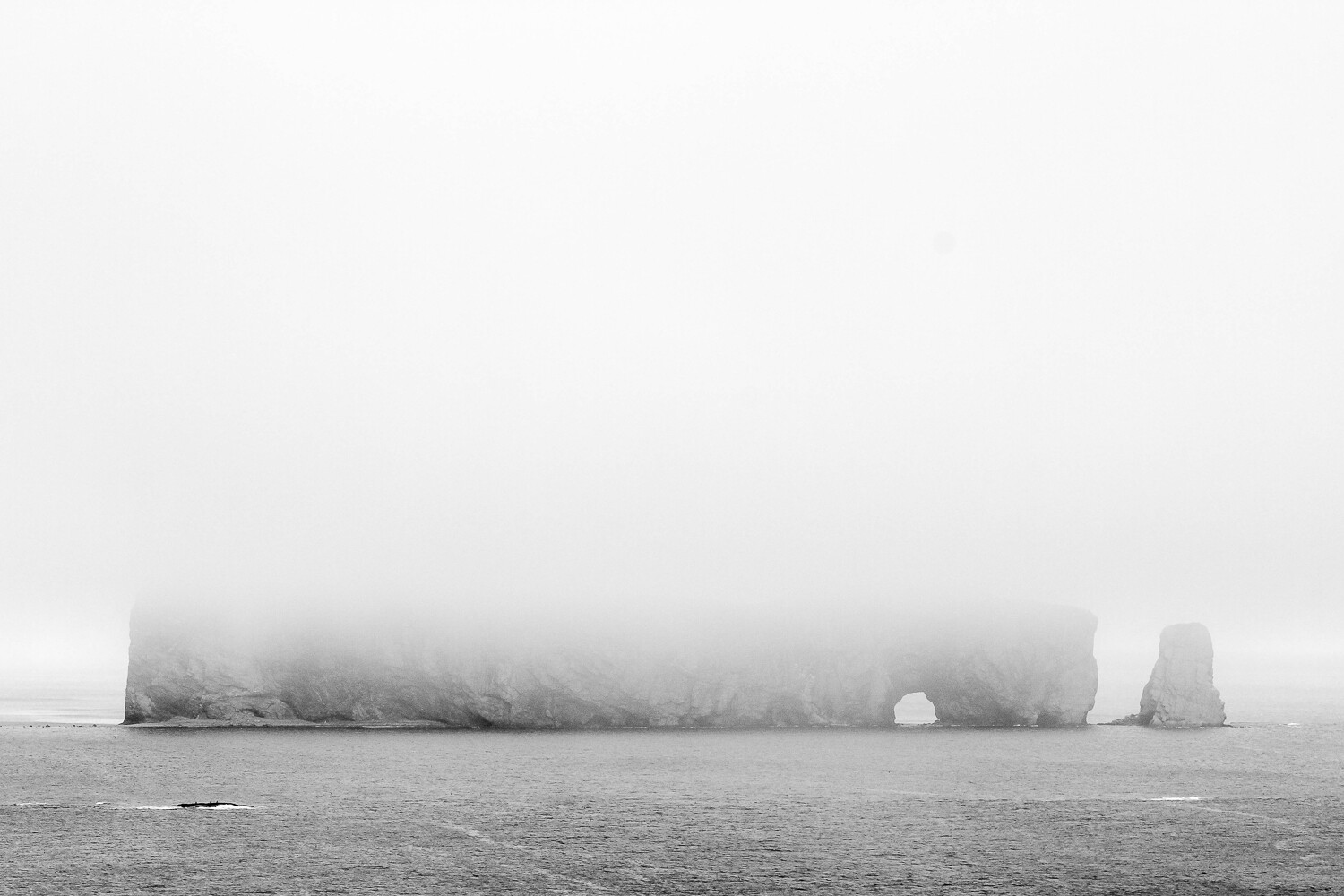 foggy rock on the water