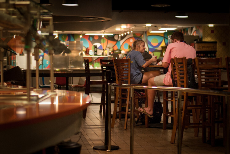 people sitting at a table in a restaurant; photographed with Program mode