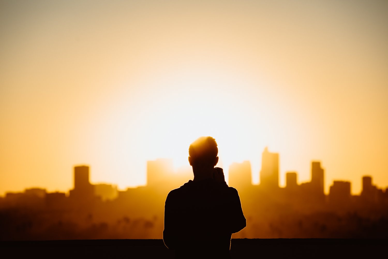 silhouette in front of a city