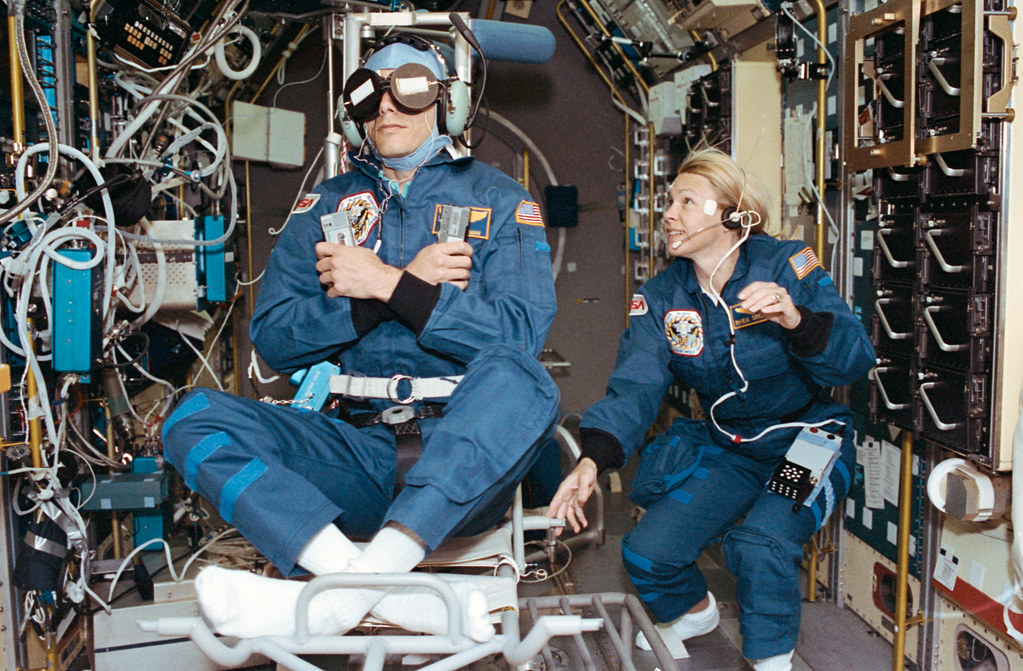 Crewmember in SPACELAB wearing the Acceleration Recording Unit and Collar.