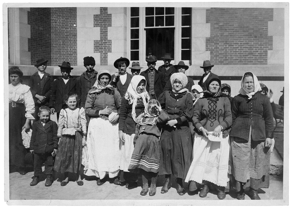 Photograph of Immigrants Outside a Building on Ellis Island